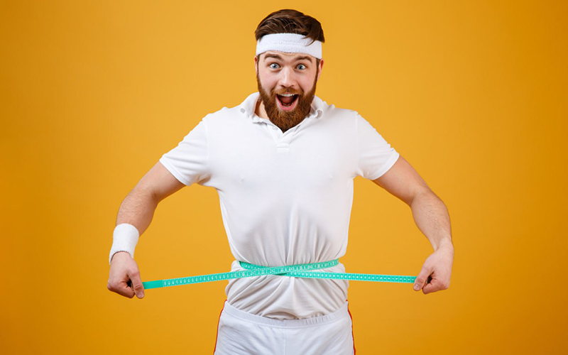 man with an inch tape around his waist